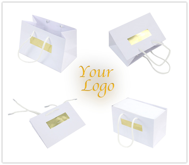 white gift bag with gold logo